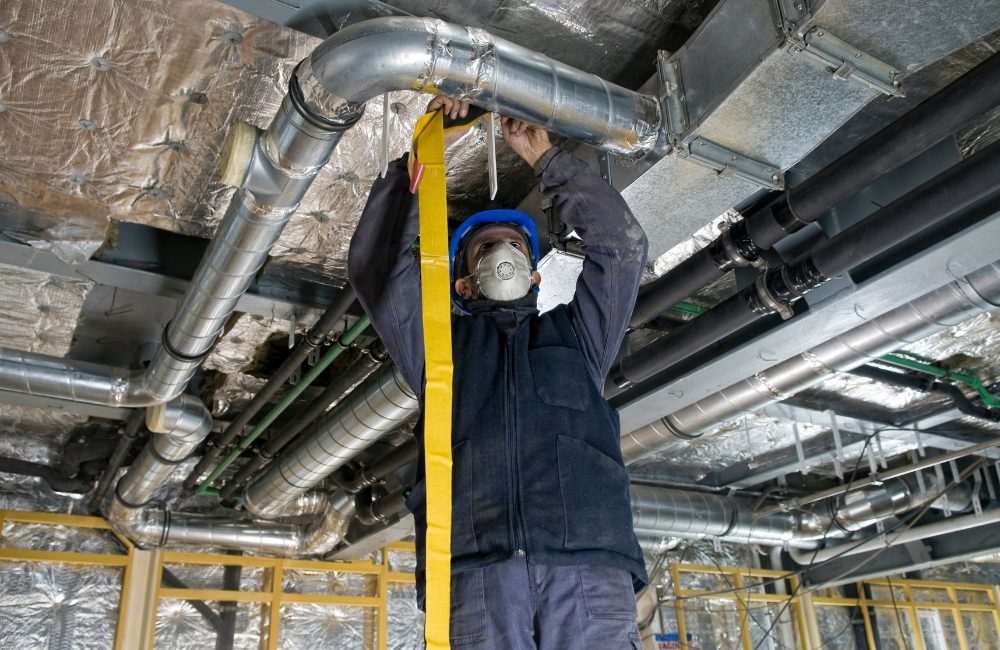 Contractor performing commercial duct cleaning service